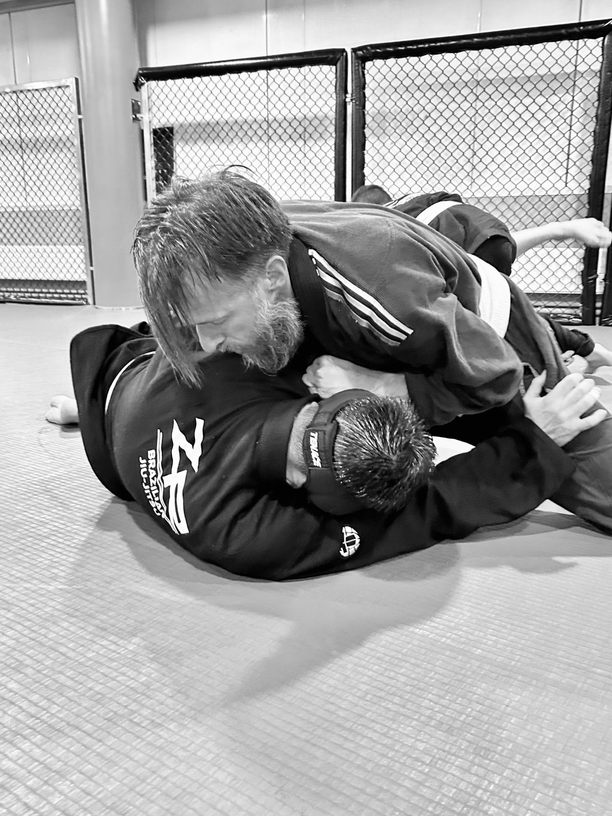 Two white belts drilling a technique together on the mats